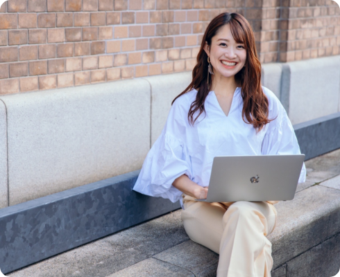 Smiling woman sitting with a computer